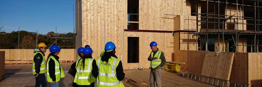 Photo of Phoenix Community Housing employees on the construction site at Nuthatch House
