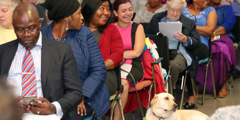 Photo of Kim Canagasabey and her guide dog Jemma at Phoenix Community Housing's annual general meeting